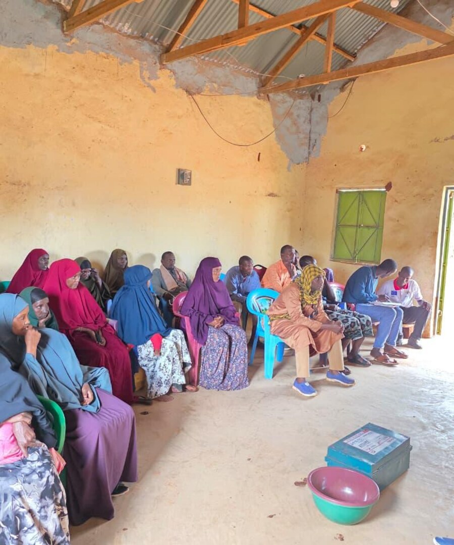 Women and elders of a community association meeting with APCINE staff