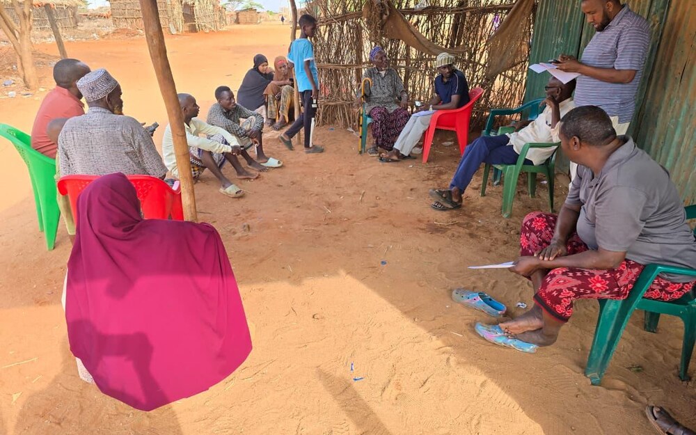 Community members in an outdoor protection and dialogue meeting